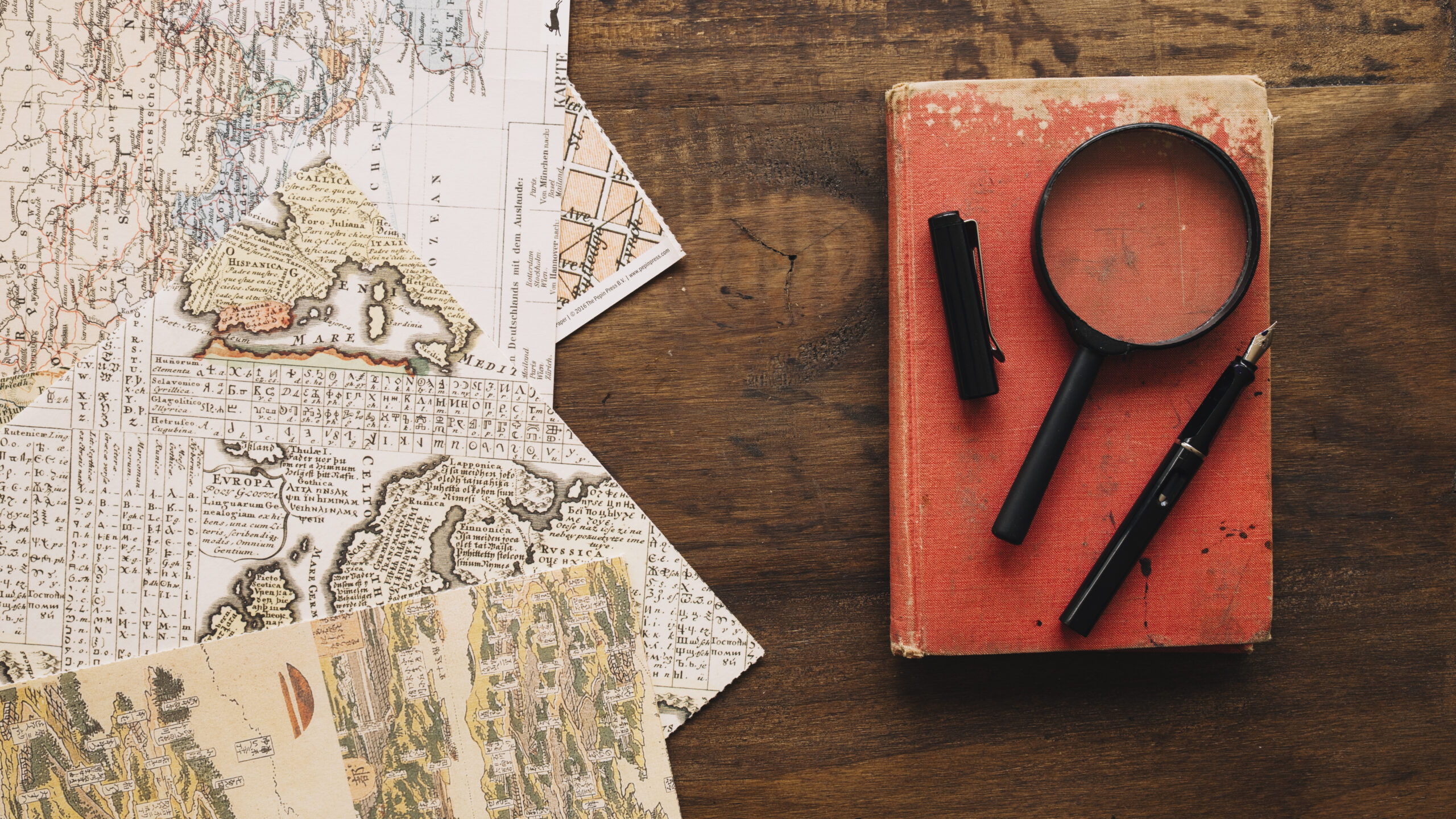 book-magnifying-glass-near-maps